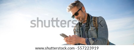 Mature man with sunglasses looking away confidently