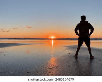 Man superhero stance silhouette on beach at sunset - Powered by Shutterstock