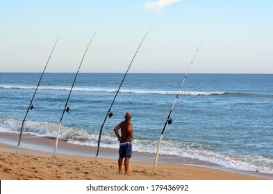 Man Surf Fishing On The East Coast Of Florida, USA.