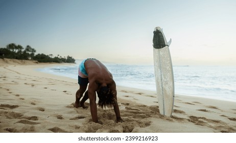 Man surfer stretching before surfing - Powered by Shutterstock