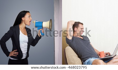 Man surfing the internet while angry woman calling him through a megaphone