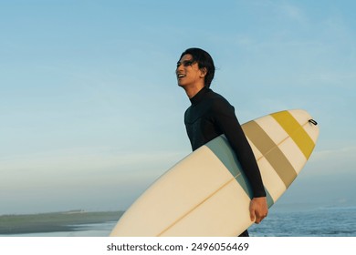 Man surfing in the morning ocean - Powered by Shutterstock