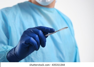 Man surgeon holds a scalpel. - Powered by Shutterstock