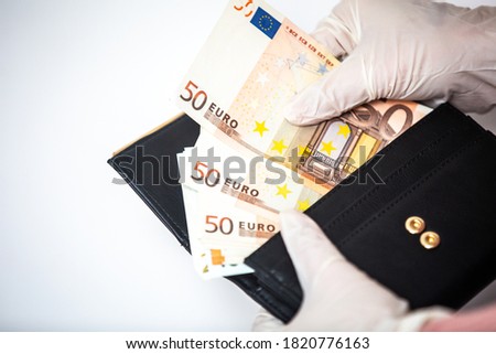 Man in surgical gloves holding Euro currency bills. Economy in new reality, economy collapse due to coronavirus pandemic.
