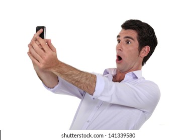 Man Surprised Watching His Mobile Phone