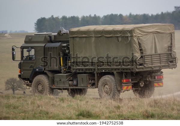 MAN SV 4x4 army logistics lorry \
vehicle truck\
driving along a dirt track in action on a military exercise,\
Salisbury Plain UK