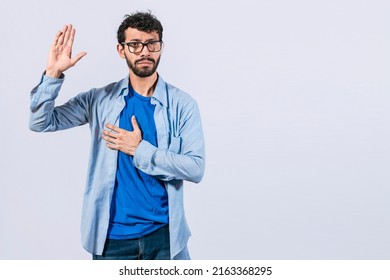 Man swearing honesty and devotion, Honest man raising his hand, a A guy raising his hand swearing, young man raising a hand promising something