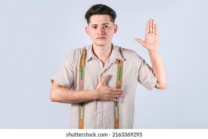 Man swearing honesty and devotion, Honest man raising his hand, a A guy raising his hand swearing, young man raising a hand promising something