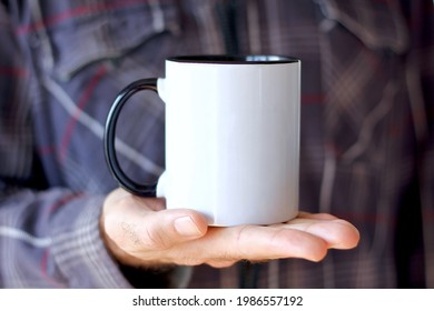 Man In Sweater Holding Blank Handle White Coffee Mug , Black Rim 11 Oz Mug Mock Up