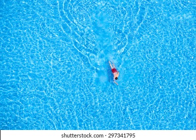 Man swim in the pool at the hotel. View from above.  - Shutterstock ID 297341795