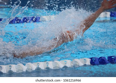 Man Swimming Back Stroke With Spash