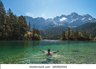 Man swimming in a beautiful mountain lake in the middle of the nature in the Bavarian Alps, Germany. European famous destination - Powered by Shutterstock