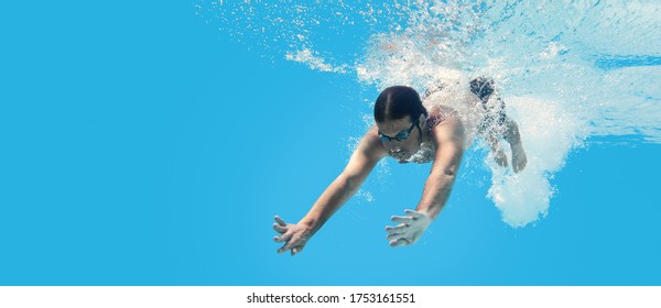 Man Swimming In The Blue Clean Water. Background With Copy Space. Under Water Training And Social Distance Concept.