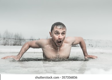Man swimming in the ice hole with emotional face