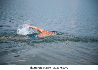 Man Swimming In Open Water Lake