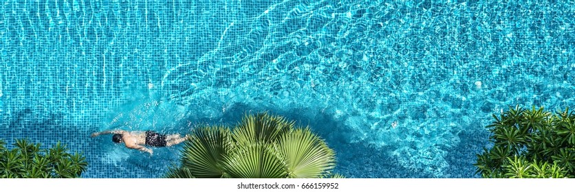 A Man Swimming In The Pool For Exercise. 