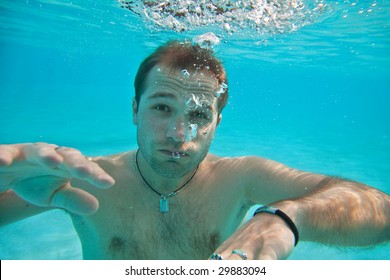 Man Swimming Under Water In Pool