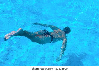 The Man Swimming Under The Water In A Pool