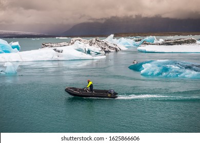 A Man Swims Through The Ice-covered Ocean On A Motor Boat, South Coast, Warm Waters Of The Gulf Stream; Iceland, Vic, December 12, 2019.