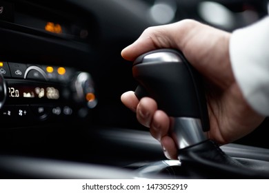 man switching gear, holding handle of the modern car, close-up view - Shutterstock ID 1473052919