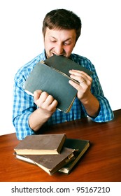 man at the table with anger biting book