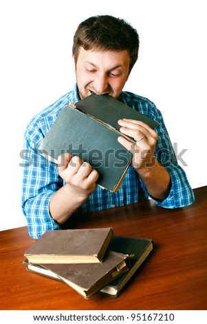 man at the table with anger biting book