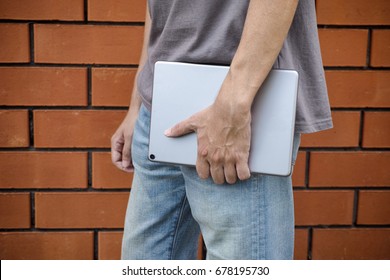 Man with tablet computer in his hand. Close up.