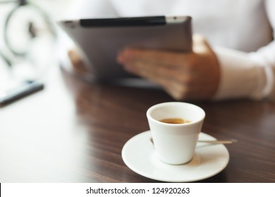 Man with tablet computer reading news at motning in cafe shop - Powered by Shutterstock