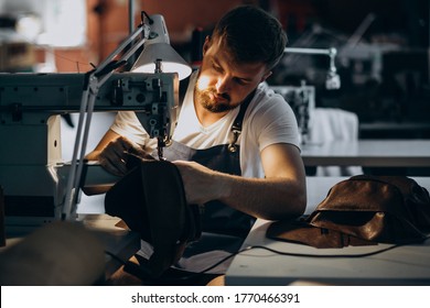 Man Tailor Working With Leather Fabric