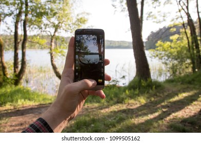 Man Takes A Picture Of Lake Fromn First Person Perspective