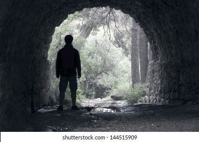 Man Takes Refuge Under The Bridge In The Rain 