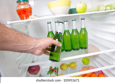 Man Taking Beer From A Fridge