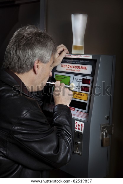Man taking breathalyzer\
test at a bar