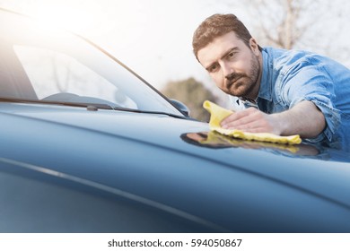 Man Taking Care And Cleaning His New Car 