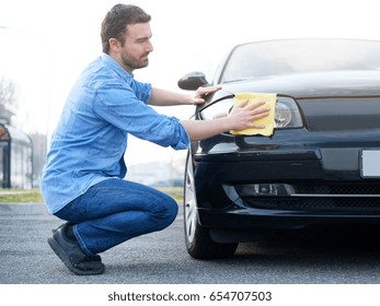 Man Taking Care And Cleaning His New Car