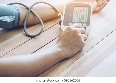 Man Is Taking Care For Health With Hearth Beat Monitor And Blood Pressure