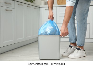 Man taking garbage bag out of bin at home, closeup - Shutterstock ID 1974265184