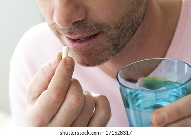 Man Taking Medication