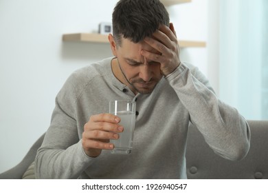 Man Taking Medicine For Hangover At Home