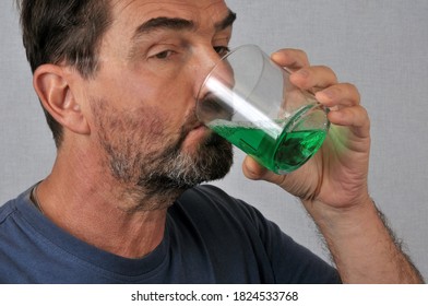 Man Taking Mouthwash Close Up