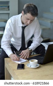 Man Taking Notes On Paper