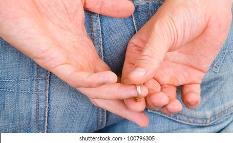 Man Taking Off His Golden Wedding Ring