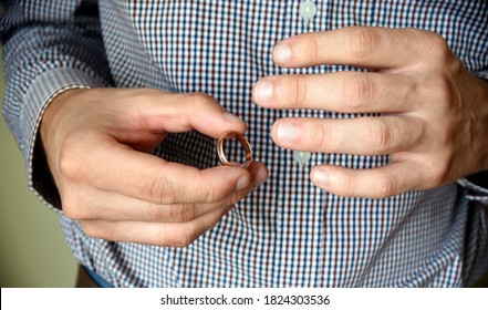 Man Taking Off His Wedding Ring. Concept Of Treason, Infidelity, Betrayal.