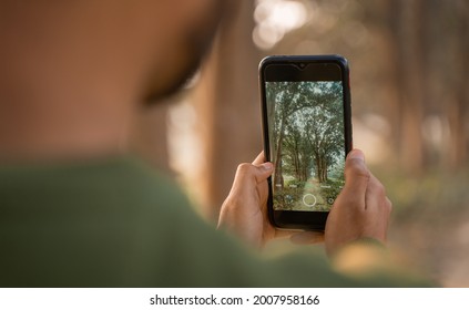 Man taking photo by phone, Mobile photographer clicking nature