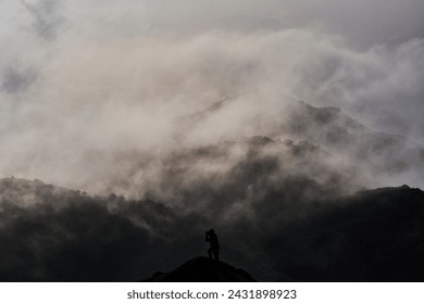 A man taking photo in a foggy mountain in Hong Kong
