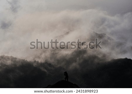 A man taking photo in a foggy mountain in Hong Kong