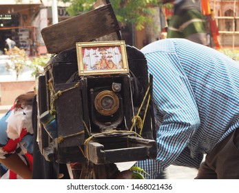 A Man Taking A Photo With His 100 Years Old Camera In Jaipur Market. Jaipur, India. February 2019