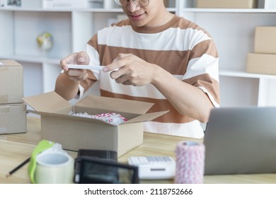 Man Taking A Photo Of Product In Box Postbox With A Mobile Phone Or Selfie, Identity Verification Or Order Confirmation, Business Style For Working At Home, Working At Home And Owning Businesses.