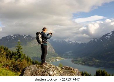 Man, Taking Pictures Of The Fjord, Hiking Mount Hoven, Enjoying The Splendid View Over Nordfjord From The Loen Skylift