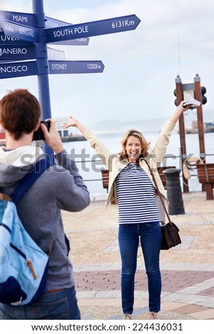 Man taking pictures of girlfriend on holiday travel vacation tourist couple